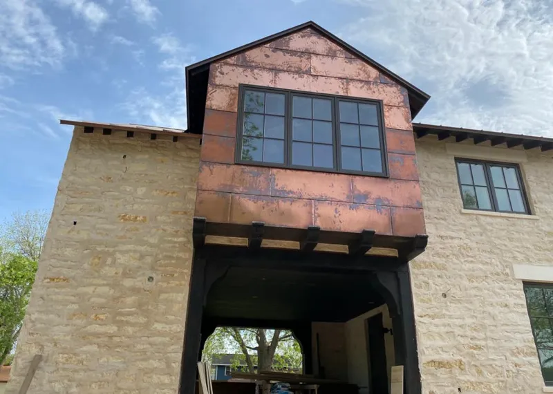 Copper metal panel facade on a stone building for Skylight Installation in El Paso